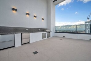 A modern kitchen with a view of the cityscape. - District 225 - Brand New Downtown Apartment (Miami)