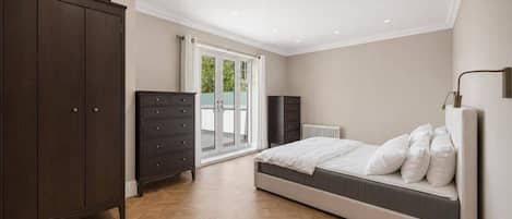 A bedroom with a bed, wardrobe, and a radiator.