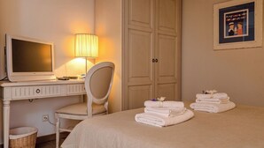 A hotel room with a bed, a desk with a computer, a chair, a wardrobe, and a framed picture on the wall. - Villa Ljuba - Private villa with pool, Hvar (Hvar)