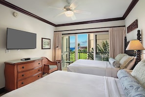 A hotel room with two beds, a television, a desk, a chair, a lamp, and a balcony with a view. - Waipouli Beach Resort H303 Ocean View 2 BD 3 BA (Kapaa)