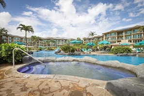 A hotel pool area with multiple pools, lounge chairs, and umbrellas. - Waipouli Beach Resort H303 Ocean View 2BD/3BA SEPT/OCT SPECIAL (Kapaa)
