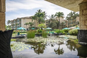 A hotel courtyard with a water feature, palm trees, and a pool. - Waipouli Beach Resort H303 Ocean View 2BD/3BA SEPT/OCT SPECIAL (Kapaa)