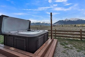 A hot tub on a wooden deck with a mountain view. - Beautiful Ranch with Hot Tub Near Mt.Princeton Hot Springs (Nathrop)