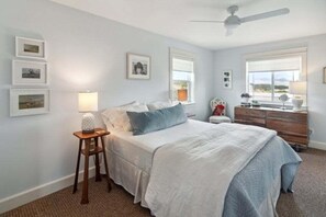 A bedroom with a bed, bedside table, lamp, dresser, and framed pictures on the wall. - Beautiful Ranch with Hot Tub Near Mt.Princeton Hot Springs (Nathrop)
