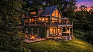 A two-story wooden house with a balcony, a fire pit, and outdoor seating. - Long-Range Views on 3 Levels | Hot Tub + Fire Pit (Maggie Valley)