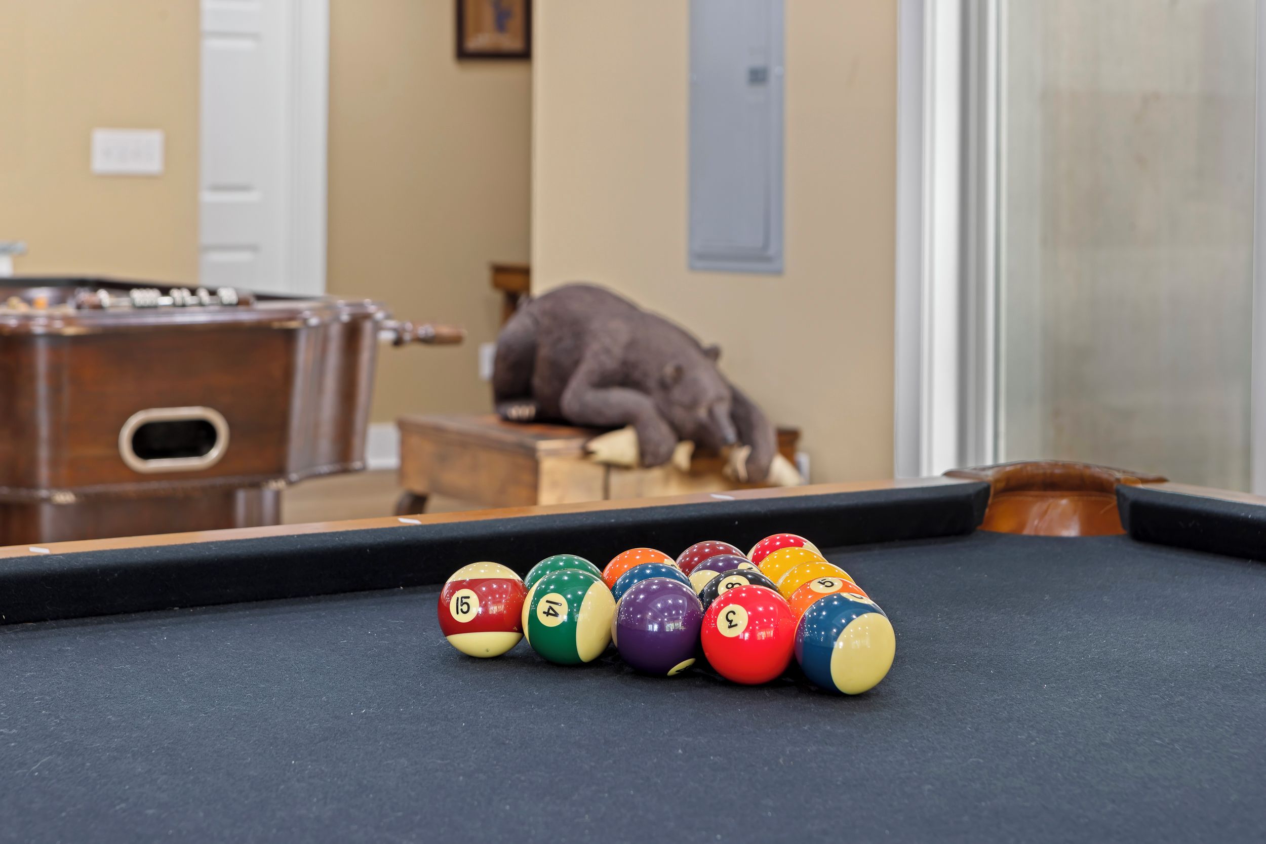 A pool table with billiard balls arranged in a line.