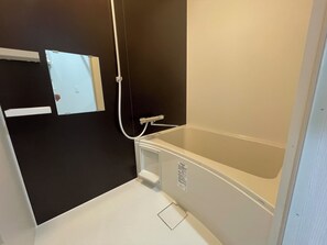 A bathroom with a bathtub, a shower, and a toilet.