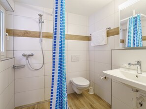 A bathroom with a shower, toilet, and sink. - Haus Astoria by Interhome (Saas-Grund)