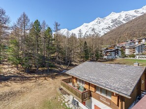 A chalet with a wooden deck and a sign reading 'Chalet Steinbock.' - Haus Alfa by Interhome (Saas-Fee)