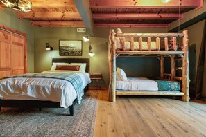 A bedroom with a wooden bunk bed, a double bed, and a wooden ceiling. - The Smoky Edit | 3 Decks | Hot Tub | Pool Table | 2 Fire Pits (Gatlinburg)