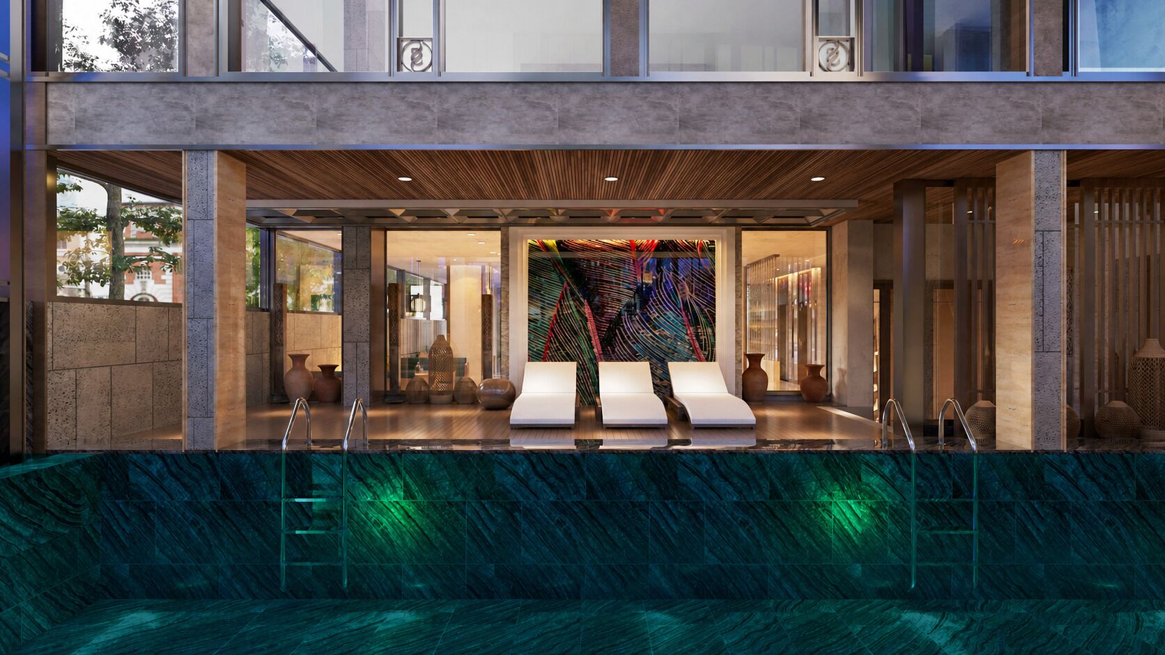 Un moderno espacio de spa con piscina, sillas de descanso e instalación artística de colores.