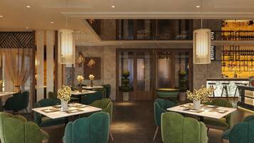 A restaurant with green upholstered chairs, white tables, and decorative vases.