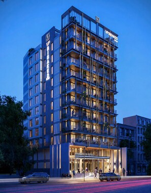 A multi-story hotel with a modern design, featuring balconies and a prominent entrance. - VP Sisaked Hotel (Vientiane)