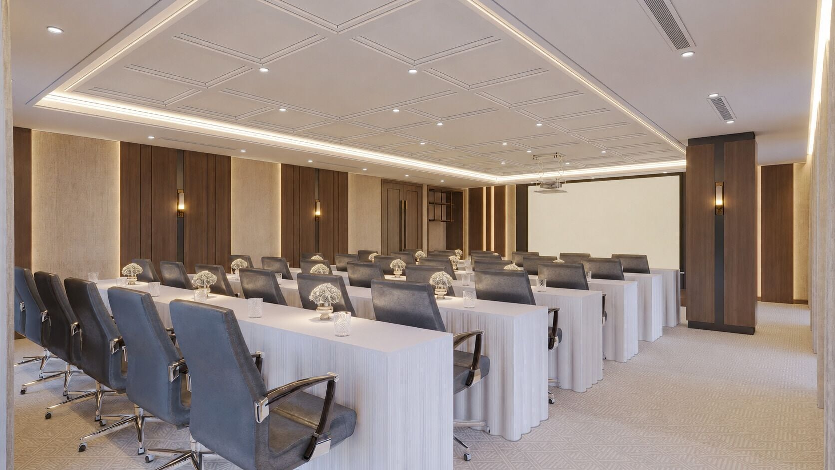 A conference room with long tables, chairs, and a projector screen.