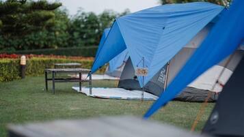 A camping area with tents and a table.