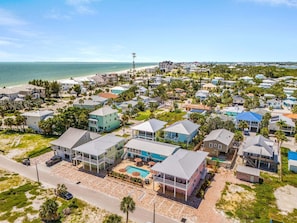 A coastal residential area with houses, a beach, and a clear sky. - Poolside Fun, Pickleball & Coastal Adventures Await in Fort Myers - Jefferson Palms 125-3  - Roelens (Fort Myers Beach)