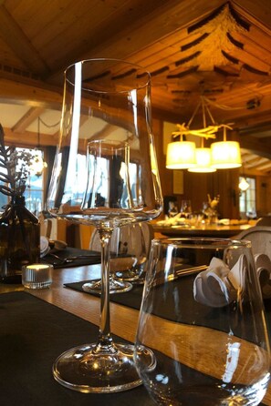 A bar area with empty wine glasses and a candle on the counter. - Schermtanne Appartement/Fewo, Bad, WC, 1 Schlafraum Wohnung Nr 4 by Interhome (Adelboden)