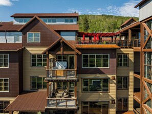 A multi-story building with balconies, large windows, and a wooden facade. - Ski-in/ski-out 3BR condo in Park City's Silver Star. (Park City)