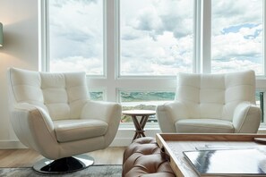 A room with two white leather armchairs facing a large window with a view of a landscape. - Deer Valley townhome with 4 bedrooms, hot tub, ski views. (Heber City)
