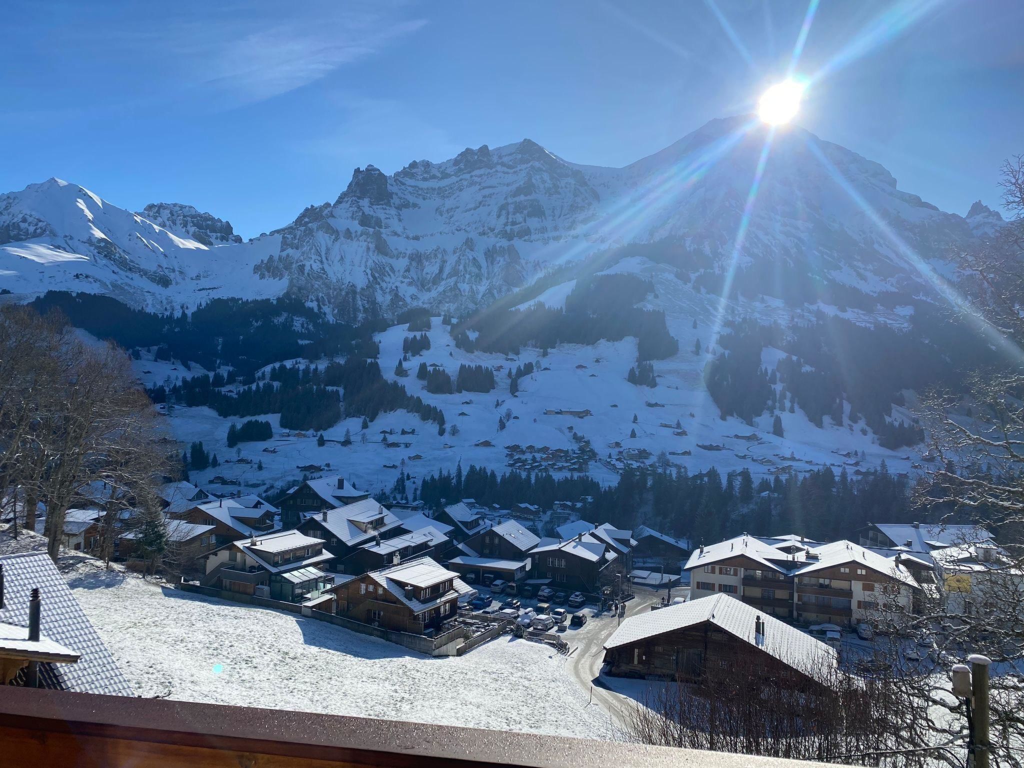 A mountain village with snow-covered houses and a clear sky.