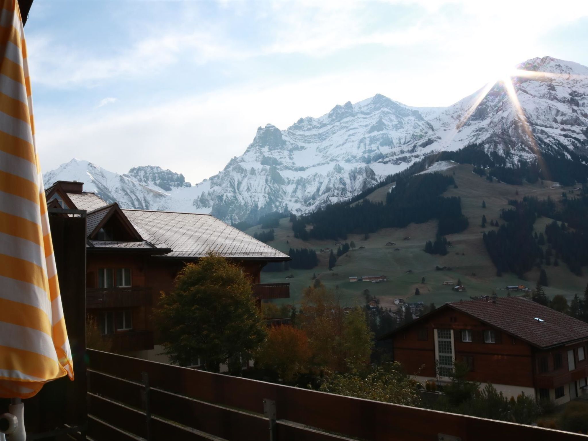 A mountain landscape with snow-capped peaks and a valley below.