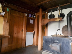 A wooden interior with a refrigerator, a sink, and a metal cabinet.