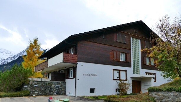 A two-story building with a stone facade and a balcony. - Silberdistel  B09 Appartement/Fewo, Bad, WC, 3 Schlafräume 3.5 Zimmerwohnung by Interhome (Adelboden)