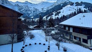 Eine verschneite Berglandschaft mit einem Skigebiet im Hintergrund.