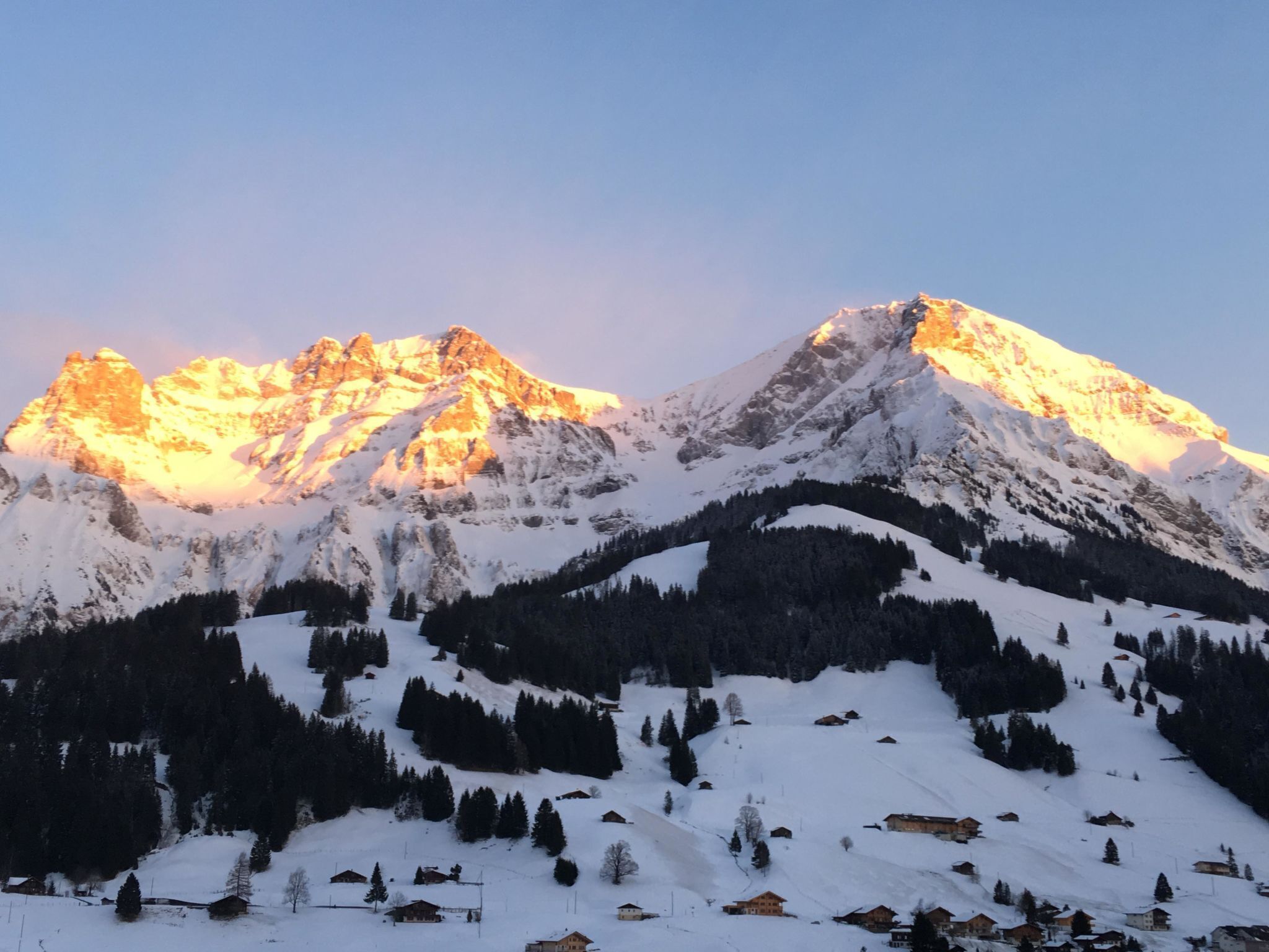 A snow-covered mountain range with a clear sky.