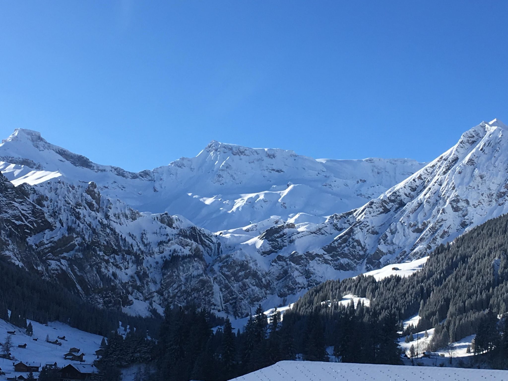 A snow-covered mountain landscape with a clear sky.