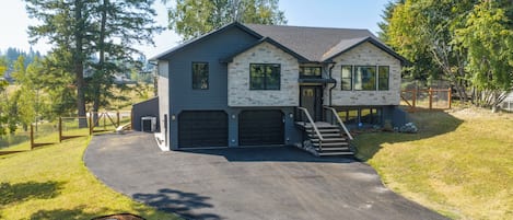 A two-story house with a garage, a driveway, and a fire hydrant.