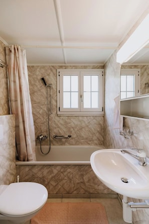 Ein Badezimmer mit Badewanne, Toilette und Waschbecken.
