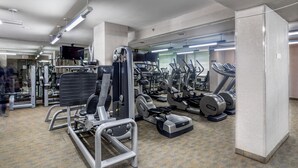 Ein Fitnessstudio mit verschiedenen Trainingsgeräten, darunter Laufbänder und Kraftgeräte.