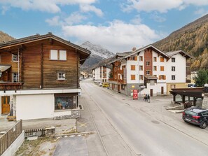 A mountain town street with wooden buildings, a clear sky, and a mountain in the background. - Haus Astoria by Interhome (Saas-Grund)