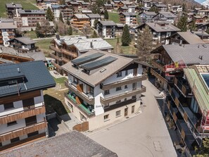 A multi-story building with a ski slope on the roof, surrounded by other residential buildings. - Haus Slalom by Interhome (Saas-Fee)