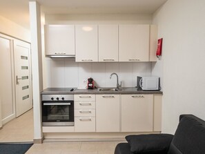 A compact kitchen with a Siemens oven, a coffee maker, a toaster, and a sink. - Haus Astoria by Interhome (Saas-Grund)