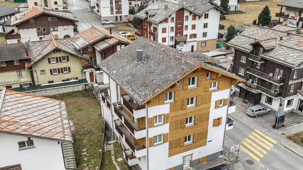 A multi-story residential building with a sloped roof, balconies, and a paved driveway. - Haus Astoria by Interhome (Saas-Grund)
