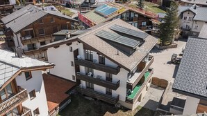 A multi-story building with balconies, a green roof, and a stone facade. - Haus Slalom by Interhome (Saas-Fee)