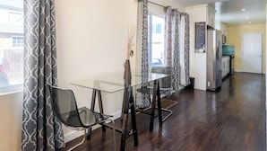 A modern kitchen with a stainless steel refrigerator, a microwave, and a storage room door. - Cozy getaway (Oakland)