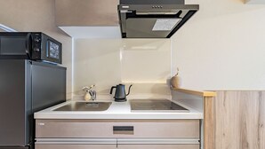 A kitchen with a stainless steel refrigerator, a built-in oven, a microwave, and a sink. - Apartment Hotel 11 Namba 2 (Osaka-shi)