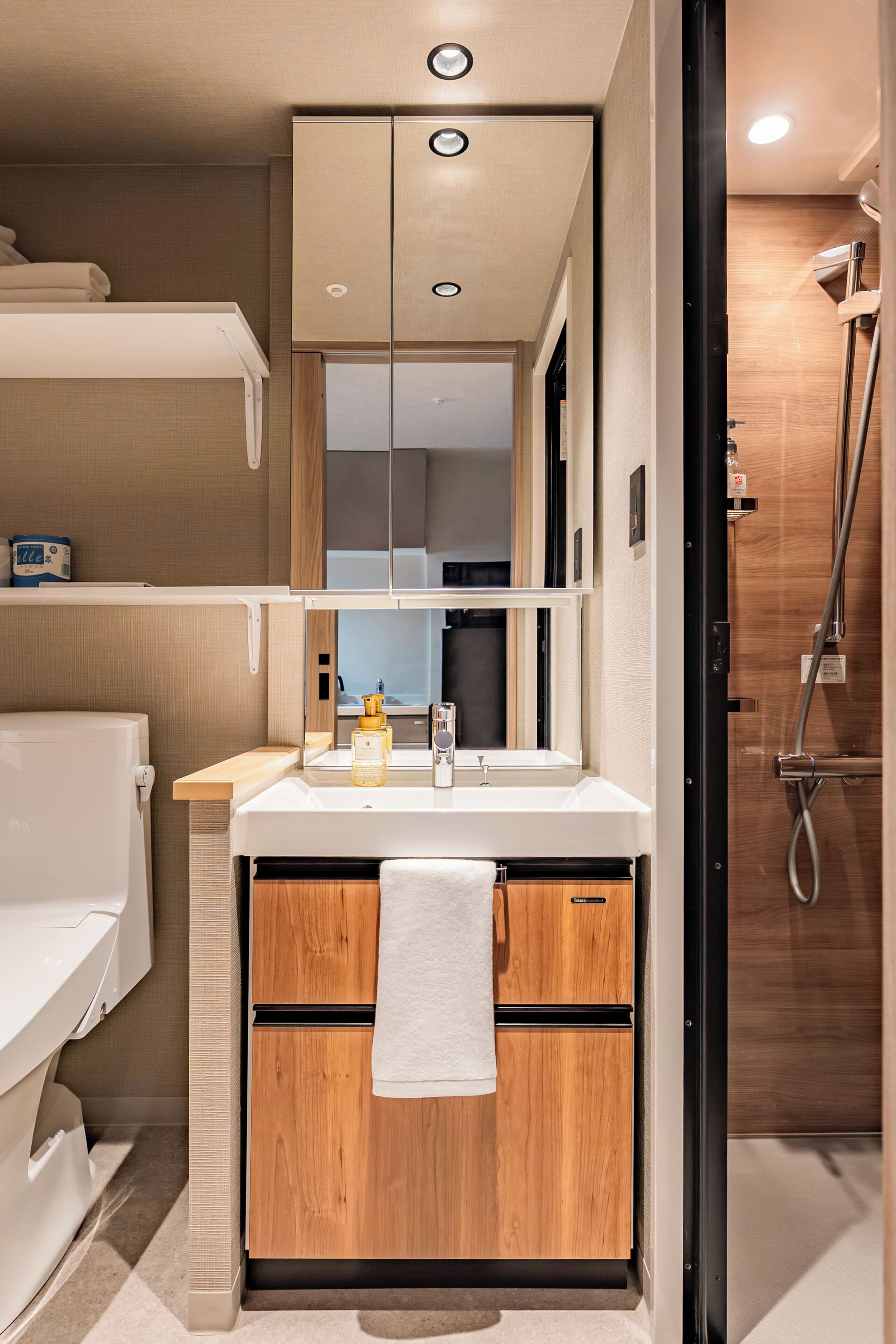 Ein kleines Badezimmer mit Dusche, Toilette und Waschbecken.
