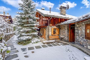 A snow-covered wooden building with stone walls, a stone staircase, and a snow-covered tree. - Courmayeur Apartment X6 Parking, Courmayeur, Italy (Courmayeur)