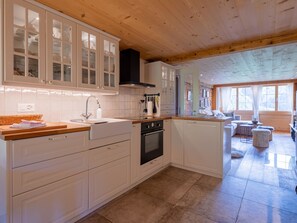 A modern kitchen with white cabinetry, a wooden countertop, and a built-in oven. - Chalet Bijou+ 1 OG Appartement/Fewo, Dusche, WC, 2 Schlafräume by Interhome (Lenk)