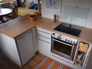 A compact kitchen with a built-in oven, a stovetop, and a sink. - Chalet Weitblick Appartement/Fewo, Dusche oder Bad, WC, Balkon by Interhome (Lenk)