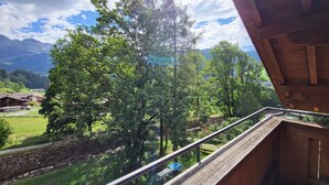 A balcony with a view of a mountainous landscape, a wooden railing, and a clear sky. - Wildbach Appartement/Fewo, Dusche oder Bad, WC, 2 Schlafräume 4-Bett-Wohnung by Interhome (Lenk)