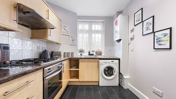 A modern kitchen with a gas stove, oven, and built-in dishwasher.