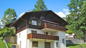 A two-story house with a balcony on the upper floor. - Pony 4-Bettwohnung Appartement/Fewo, Dusche oder Bad, WC, 1 Schlafraum by Interhome (Lenk)