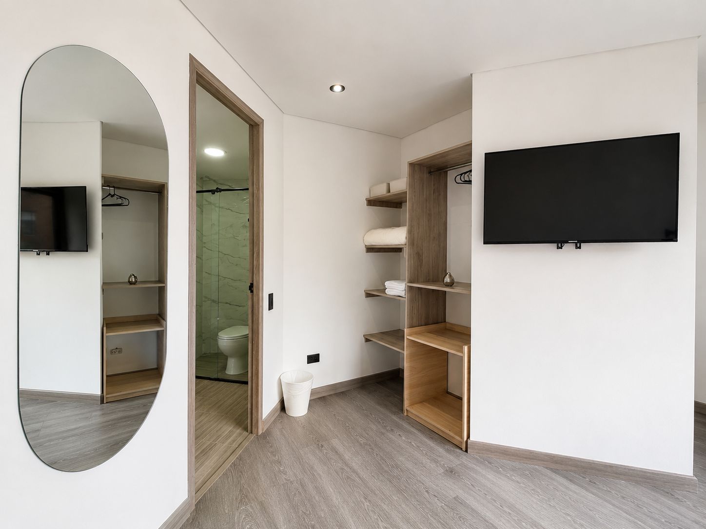 A modern bathroom with a shower, toilet, and vanity.