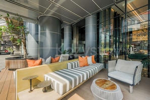 A modern lounge area with a sofa, armchairs, and a coffee table.