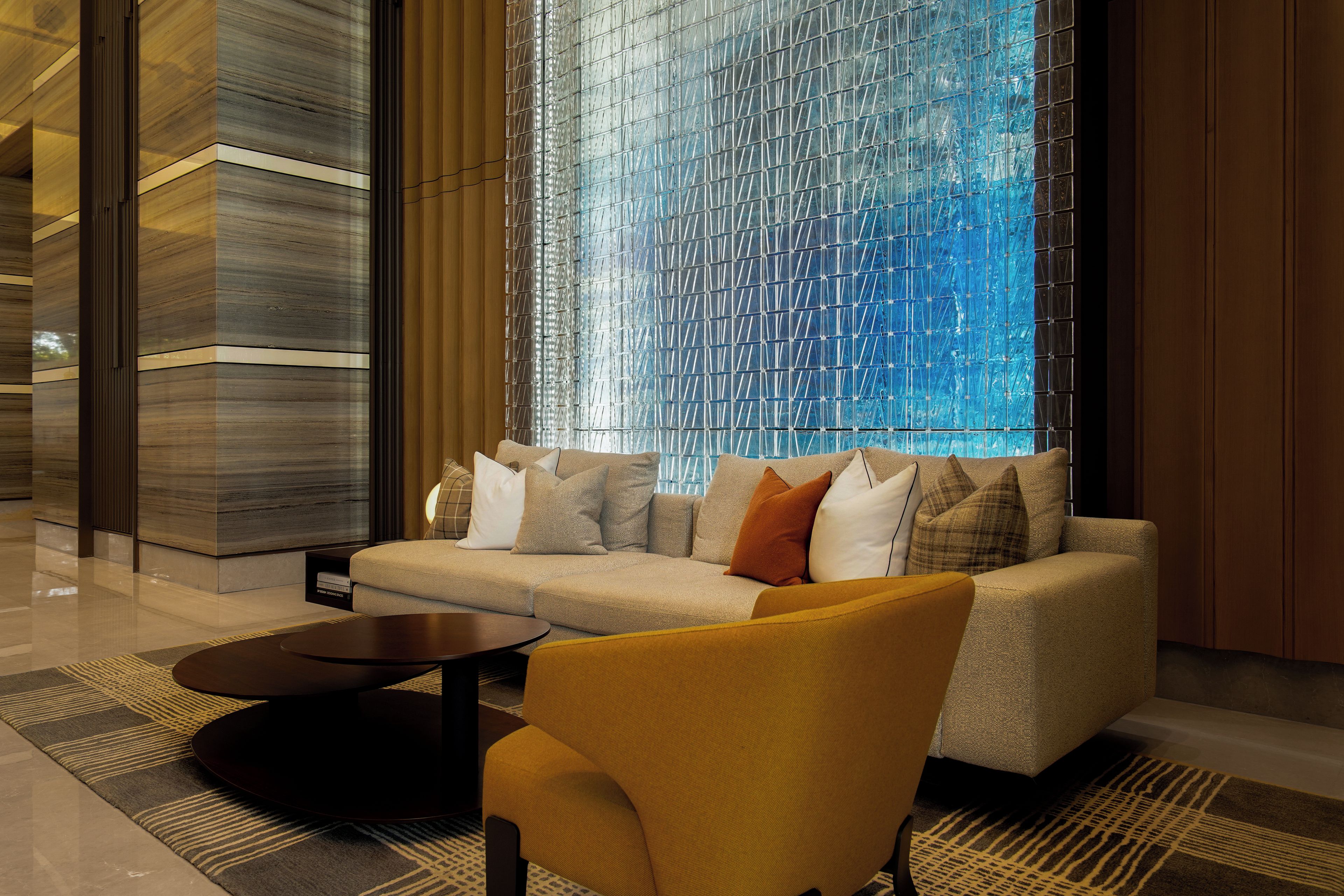 A modern interior with a sofa, armchair, and coffee table.